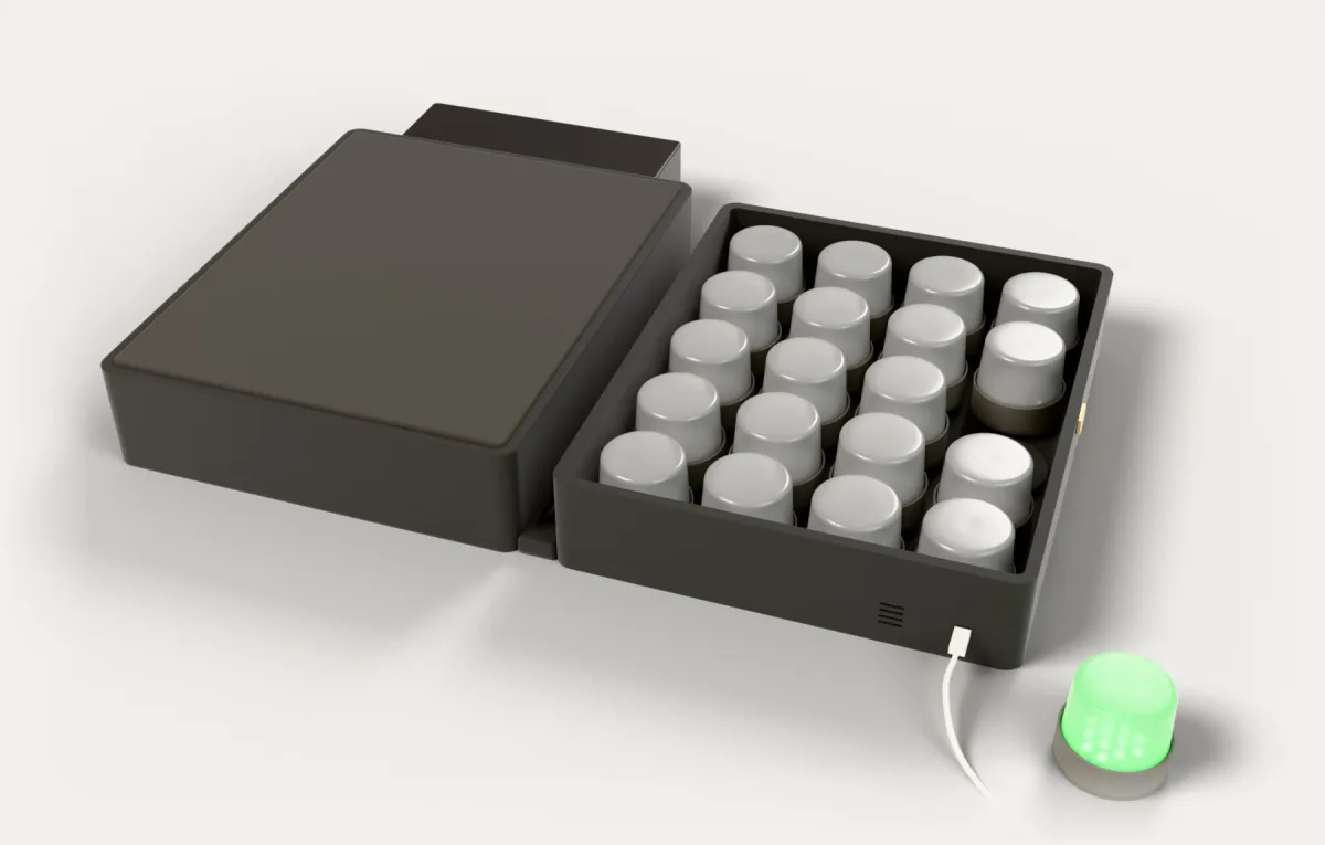 The case open like a book: twenty shrouds in their pockets, a USB-C cable, and one shroud lifted out glowing green.